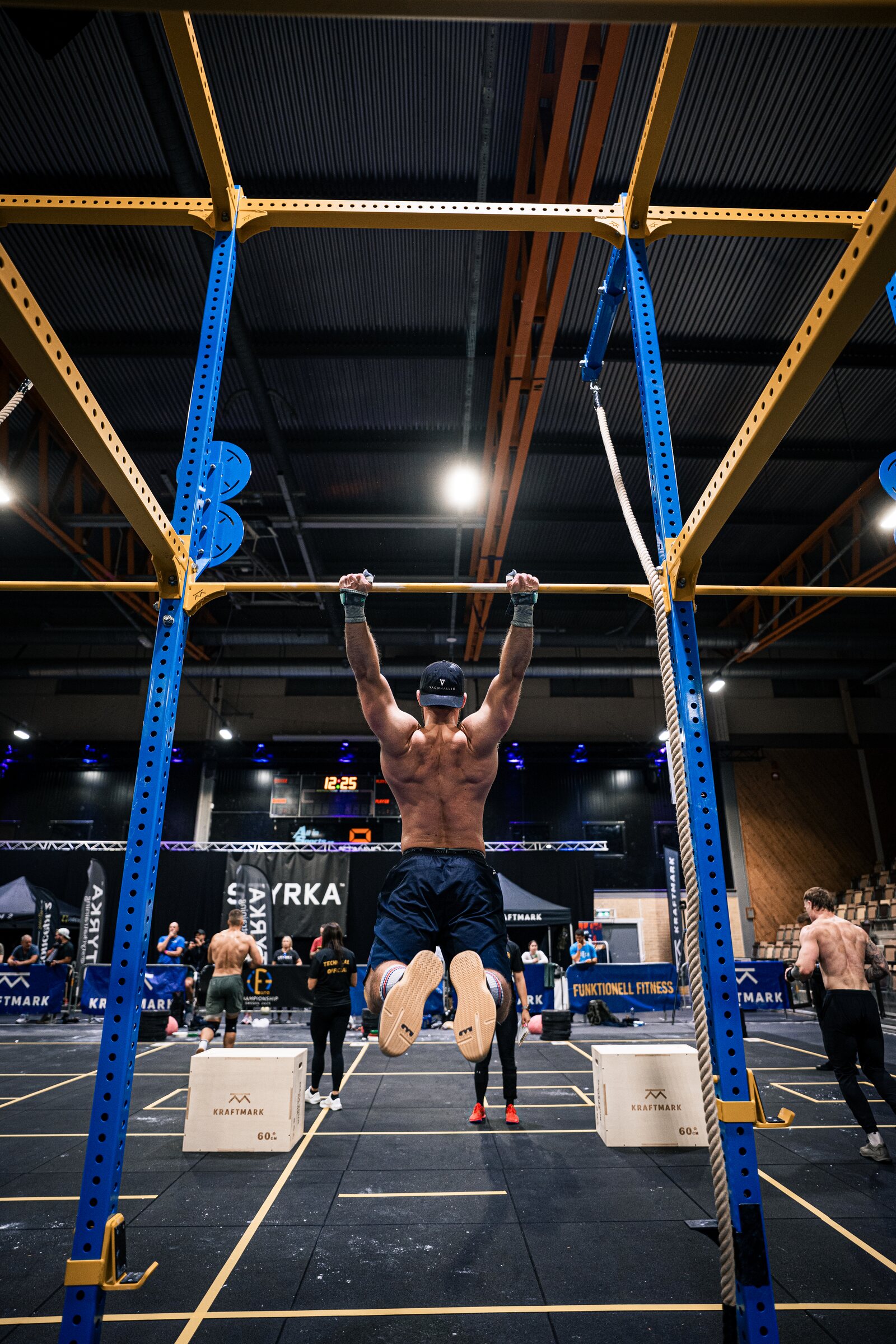 Christian Hartmann performing pull-ups at a European functional fitness competition